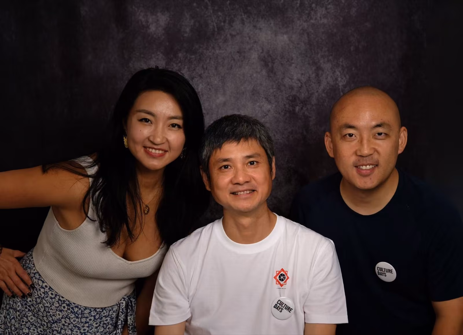 CCVAA board members, from left: Yaqi Jing, Zhong Liu, and Albert Zang, smiling together in front of a dark studio backdrop.